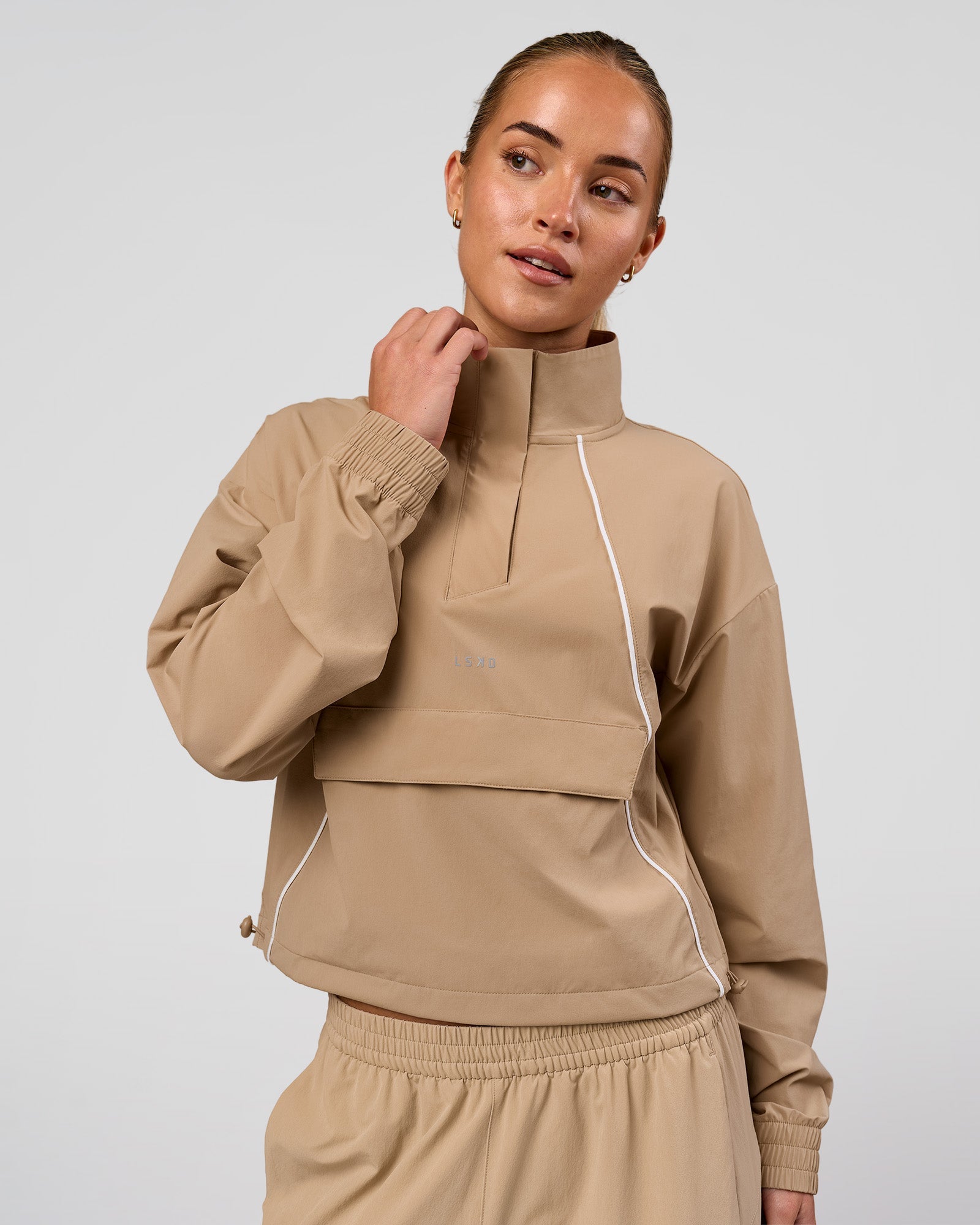 Woman wearing Pop Over Jacket - Warm Smoke | Model:Issy | Size:XS