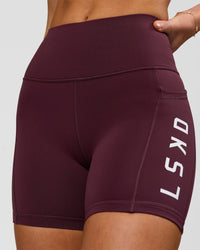 Woman wearing Rep Ultra High-Rise 4" Short Pockets - Cherry Lacquer-White | Model:Issy | Size:XS | Thumbnail Index: 0
