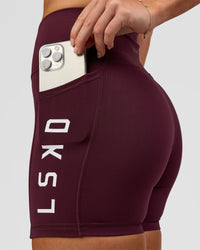 Woman wearing Rep Ultra High-Rise 4" Short Pockets - Cherry Lacquer-White | Model:Issy | Size:XS | Thumbnail Index: 5