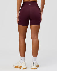 Woman wearing Rep Ultra High-Rise 4" Short Pockets - Cherry Lacquer-White | Model:Issy | Size:XS | Thumbnail Index: 7
