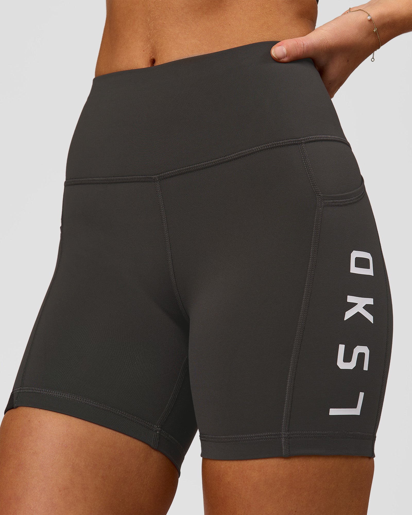 Woman wearing Rep Ultra High-Rise 4" Short Pockets - Onyx-White | Model:Issy | Size:XS