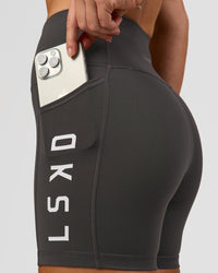 Woman wearing Rep Ultra High-Rise 4" Short Pockets - Onyx-White | Model:Issy | Size:XS | Thumbnail Index: 1