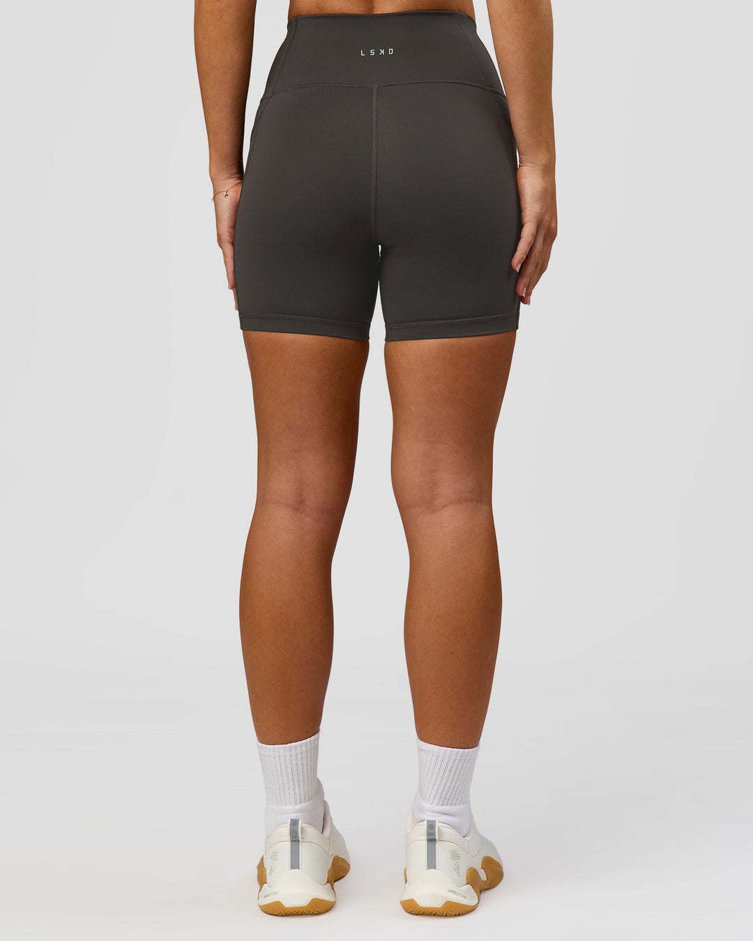 Woman wearing Rep Ultra High-Rise 4" Short Pockets - Onyx-White | Model:Issy | Size:XS - view 5