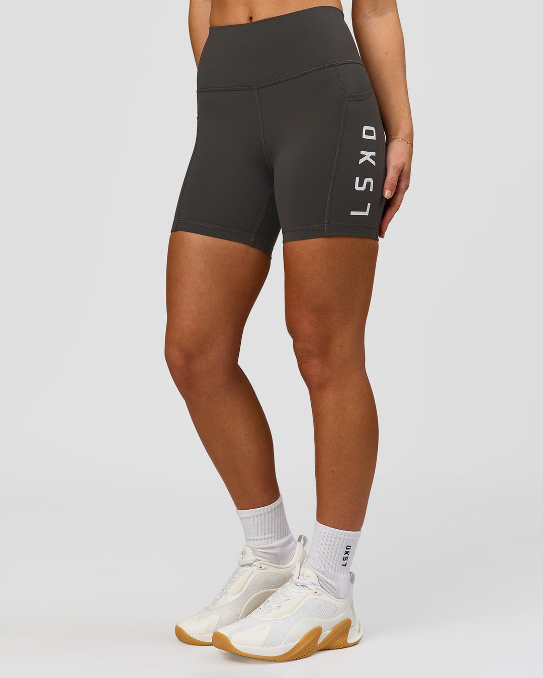 Woman wearing Rep Ultra High-Rise 4" Short Pockets - Onyx-White | Model:Issy | Size:XS - view 7