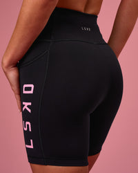 Woman wearing Rep Ultra High-Rise 6" Short Pockets - Black-Pink Rose | Model:Issy | Size:XS | Thumbnail Index: 5