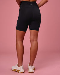 Woman wearing Rep Ultra High-Rise 6" Short Pockets - Black-Pink Rose | Model:Issy | Size:XS | Thumbnail Index: 2