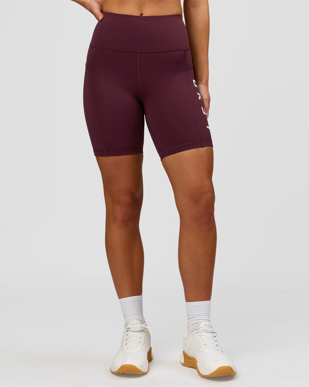 Woman wearing Rep Ultra High-Rise 6" Short Pockets - Cherry Lacquer-White | Model:Issy | Size:XS - view 3