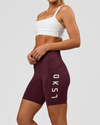 Woman wearing Rep Ultra High-Rise 6" Short Pockets - Cherry Lacquer-White | Model:Issy | Size:XS | Thumbnail Index: 0