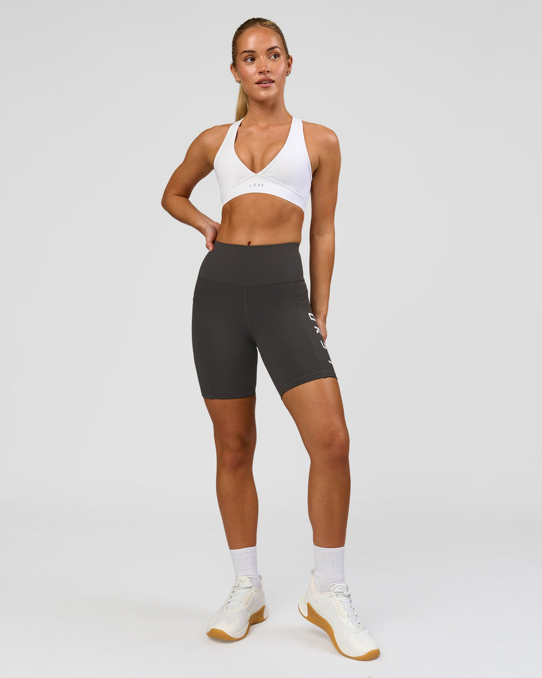 Woman wearing Rep Ultra High-Rise 6" Short Pockets - Onyx-white | Model:Issy | Size:XS - view 7