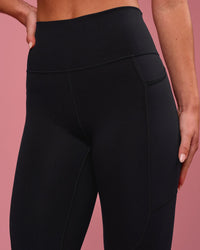 Woman wearing Rep Ultra High-Rise 7/8 Legging Pockets - Black-Pink Rose | Model:Issy | Size:XS | Thumbnail Index: 4