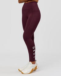 Woman wearing Rep Ultra High-Rise 7/8 Legging Pockets - Cherry Lacquer-White | Model:Issy | Size:XS | Thumbnail Index: 3