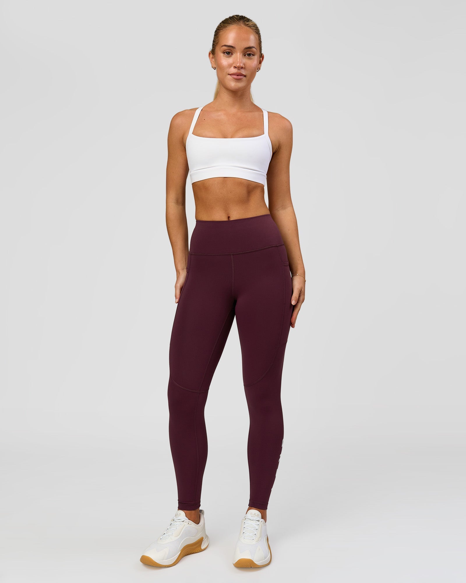 Woman wearing Rep Ultra High-Rise 7/8 Legging Pockets - Cherry Lacquer-White | Model:Issy | Size:XS