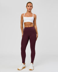 Woman wearing Rep Ultra High-Rise 7/8 Legging Pockets - Cherry Lacquer-White | Model:Issy | Size:XS | Thumbnail Index: 0