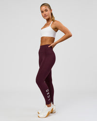 Woman wearing Rep Ultra High-Rise 7/8 Legging Pockets - Cherry Lacquer-White | Model:Issy | Size:XS | Thumbnail Index: 1
