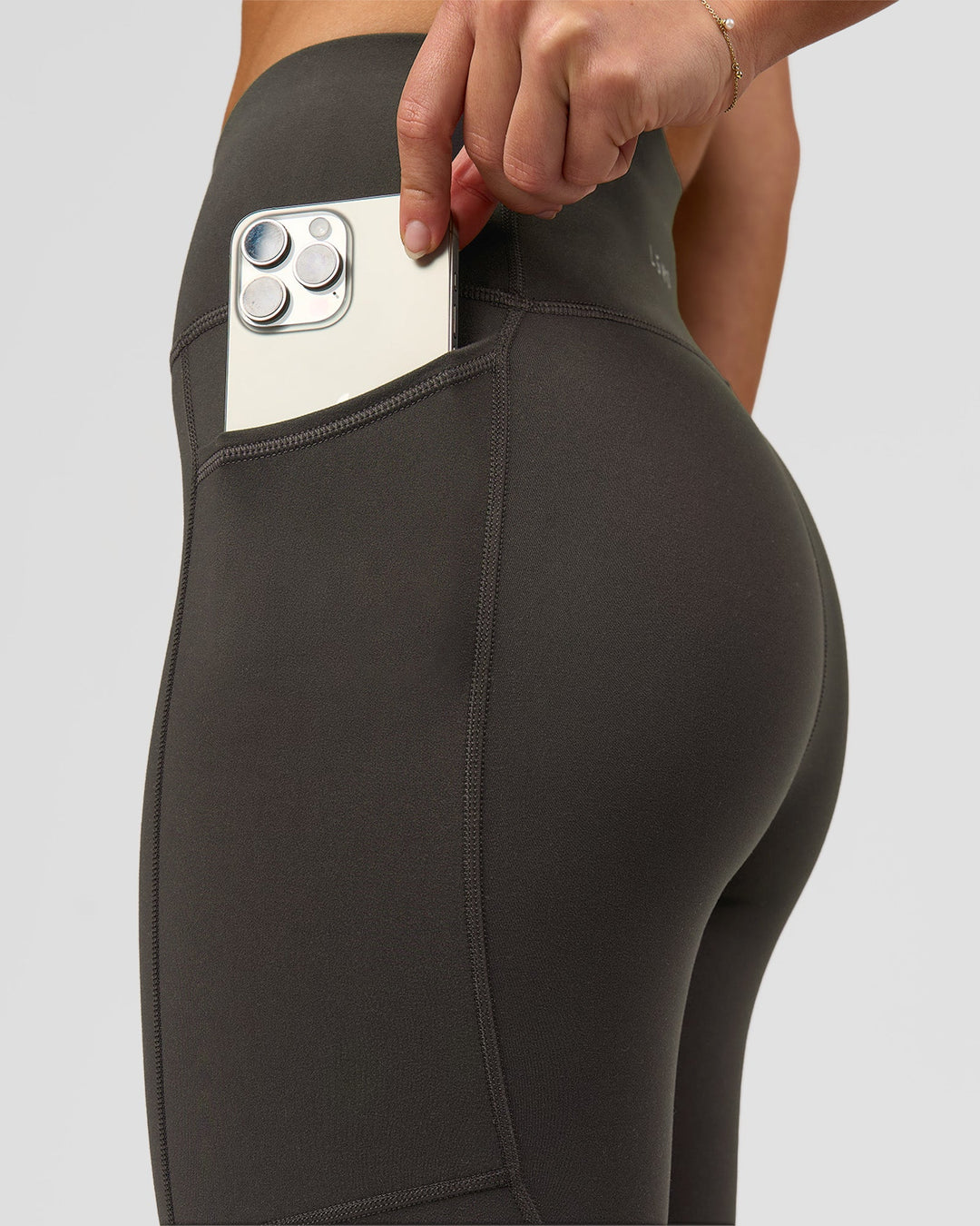 Woman wearing Rep Ultra High-Rise 7/8 Legging Pockets - Onyx-white | Model:Issy | Size:XS - view 2