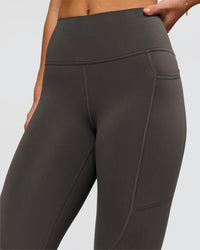 Woman wearing Rep Ultra High-Rise 7/8 Legging Pockets - Onyx-white | Model:Issy | Size:XS | Thumbnail Index: 3