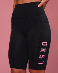 Woman wearing Rep Ultra High-Rise 9" Short Pockets - Black-Pink Rose | Model:Issy | Size:XS | Thumbnail Index: 1