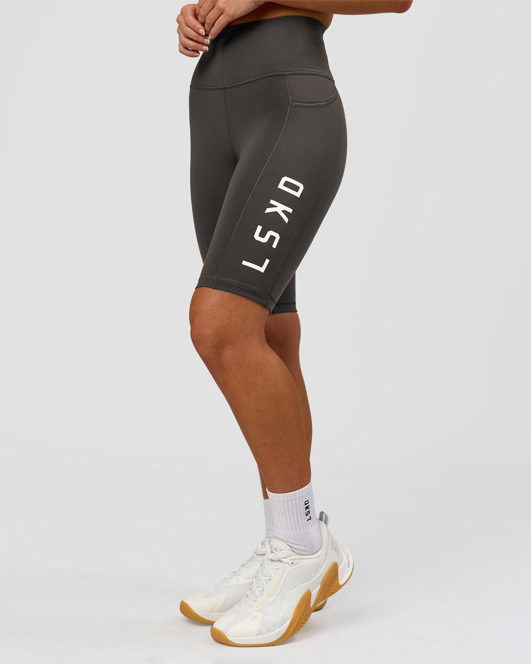 Woman wearing Rep Ultra High-Rise 9" Short Pockets - Onyx-white | Model:Issy | Size:XS - view 1