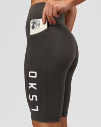 Woman wearing Rep Ultra High-Rise 9" Short Pockets - Onyx-white | Model:Issy | Size:XS | Thumbnail Index: 1