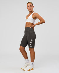 Woman wearing Rep Ultra High-Rise 9" Short Pockets - Onyx-white | Model:Issy | Size:XS | Thumbnail Index: 4