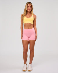 Woman wearing RXD Mid-Rise 4" Short - Pink Rose | Model:Issy | Size:XS | Thumbnail Index: 5