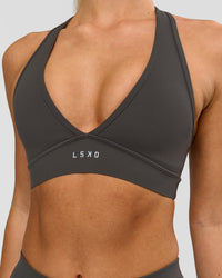 Woman wearing Stamina Sports Bra - Onyx | Model:Issy | Size:XS | Thumbnail Index: 0