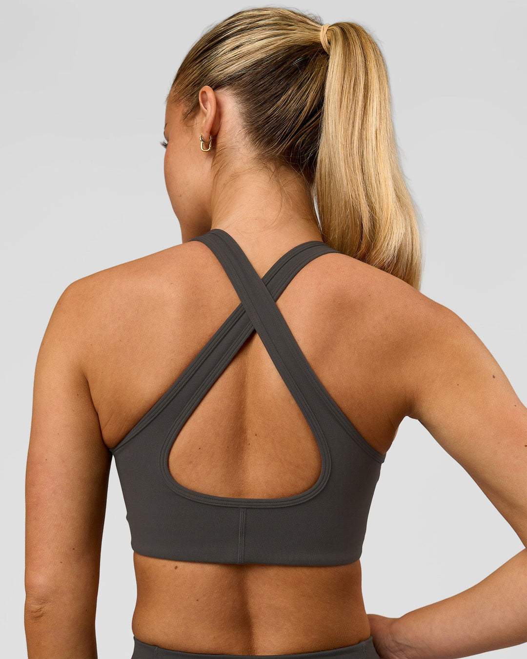 Woman wearing Stamina Sports Bra - Onyx | Model:Issy | Size:XS - view 4