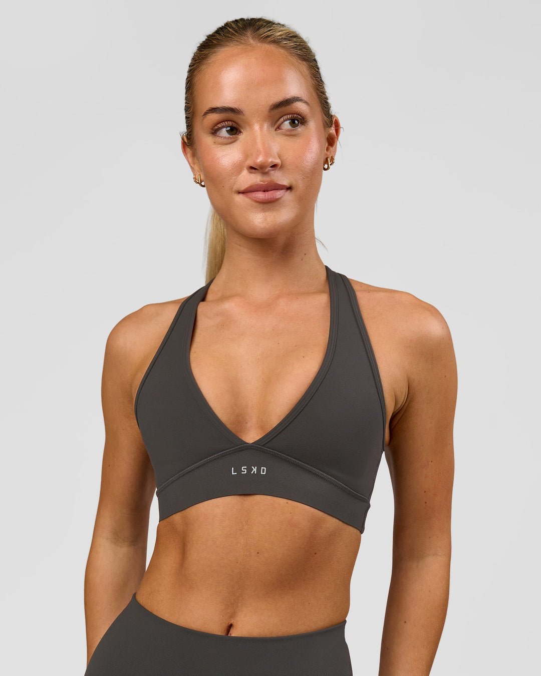 Woman wearing Stamina Sports Bra - Onyx | Model:Issy | Size:XS - view 3