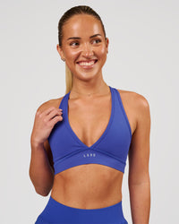 Woman wearing Stamina Sports Bra - Power Cobalt | Model:Issy | Size:XS | Thumbnail Index: 1