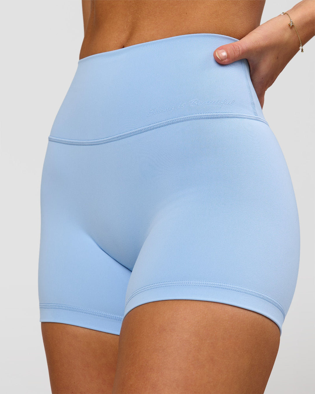 Woman wearing Strong is Beautiful Fusion High-Rise 4" Short - Open Air | Model:Issy | Size:XS - view 5