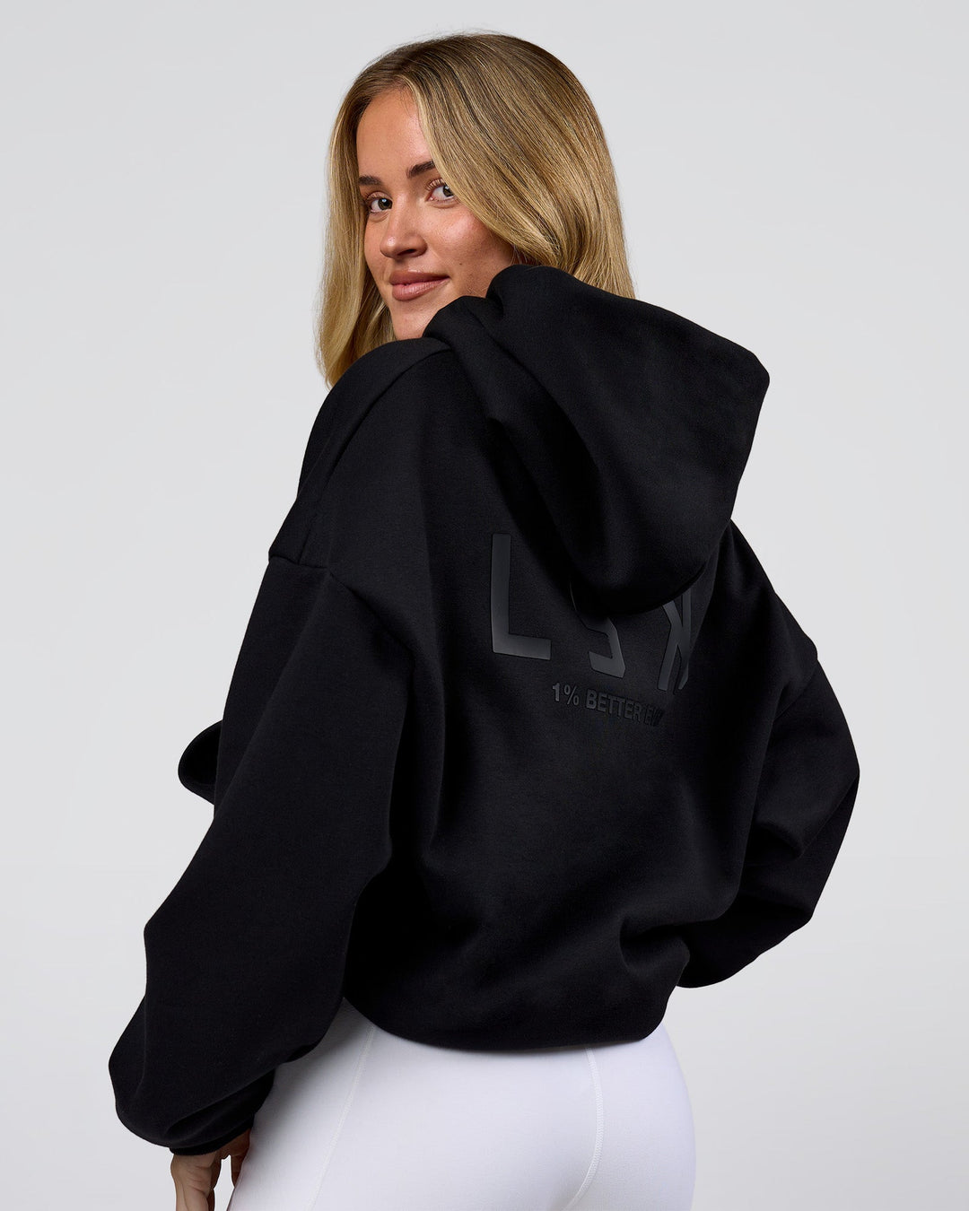 Woman wearing Tonal Legacy Boxy Hoodie - Black-Black | Model:Issy | Size:XS - view 9
