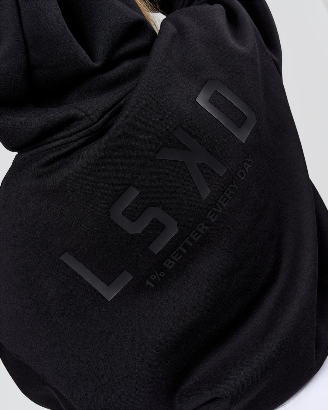 Woman wearing Tonal Legacy Boxy Hoodie - Black-Black | Model:Issy | Size:XS - view 11