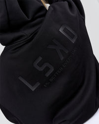 Woman wearing Tonal Legacy Boxy Hoodie - Black-Black | Model:Issy | Size:XS | Thumbnail Index: 10