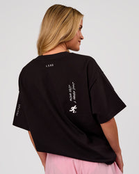 Woman wearing Values Manifesto Heavyweight Oversized Tee  - Black-White | Model:Issy | Size:XS | Thumbnail Index: 5