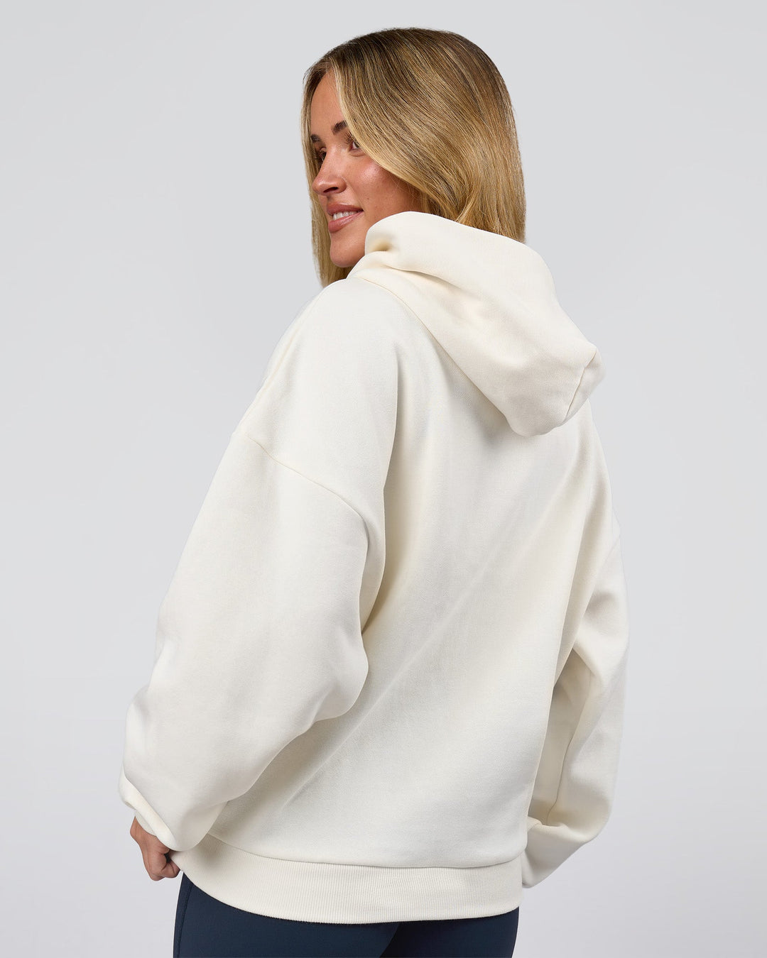 Woman wearing Varsity Boxy Hoodie - Off White-Pink Rose | Model:Issy | Size:XS - view 13