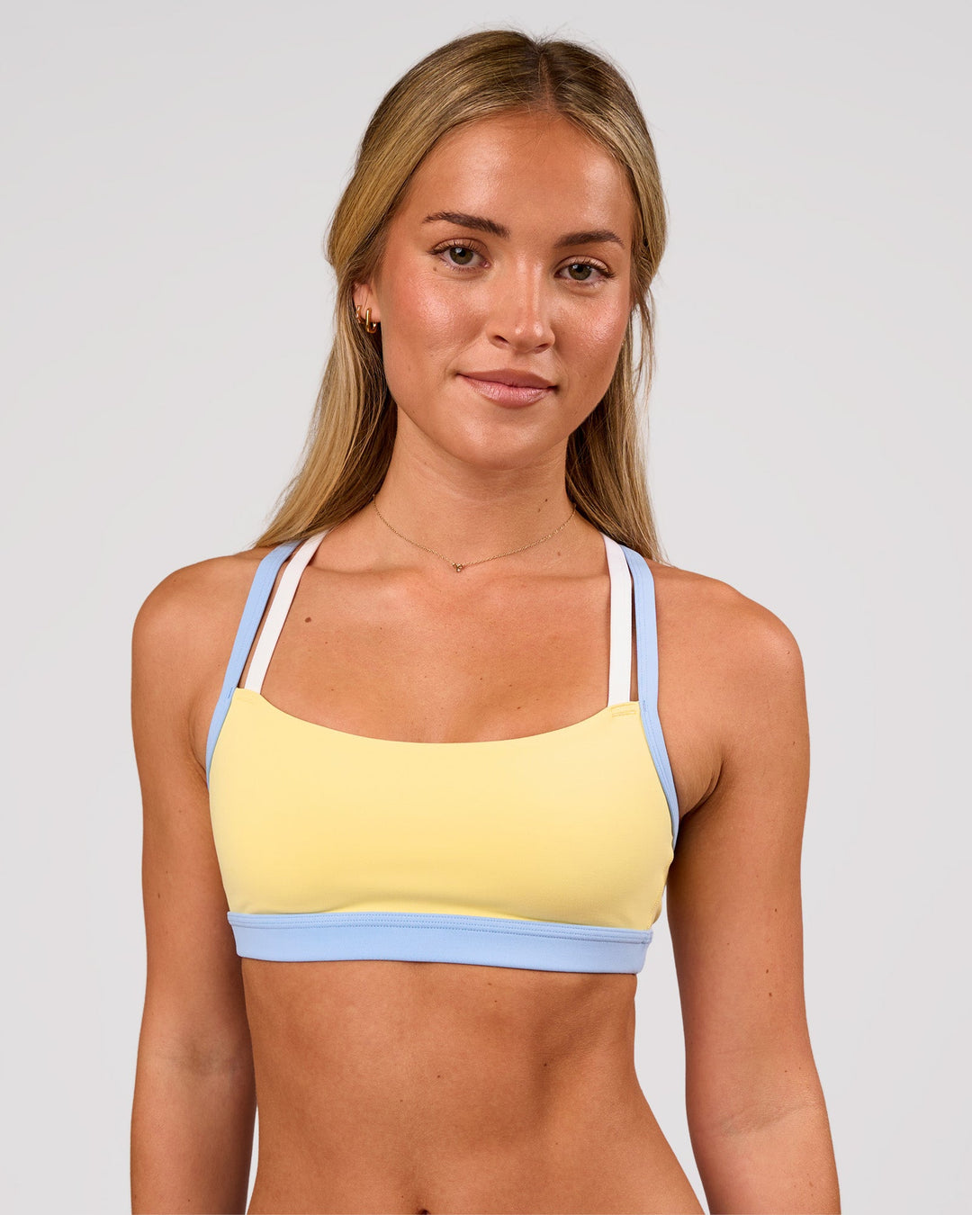 Woman wearing Velocity Sports Bra - Lemon-Open Air | Model:Issy | Size:XS - view 3