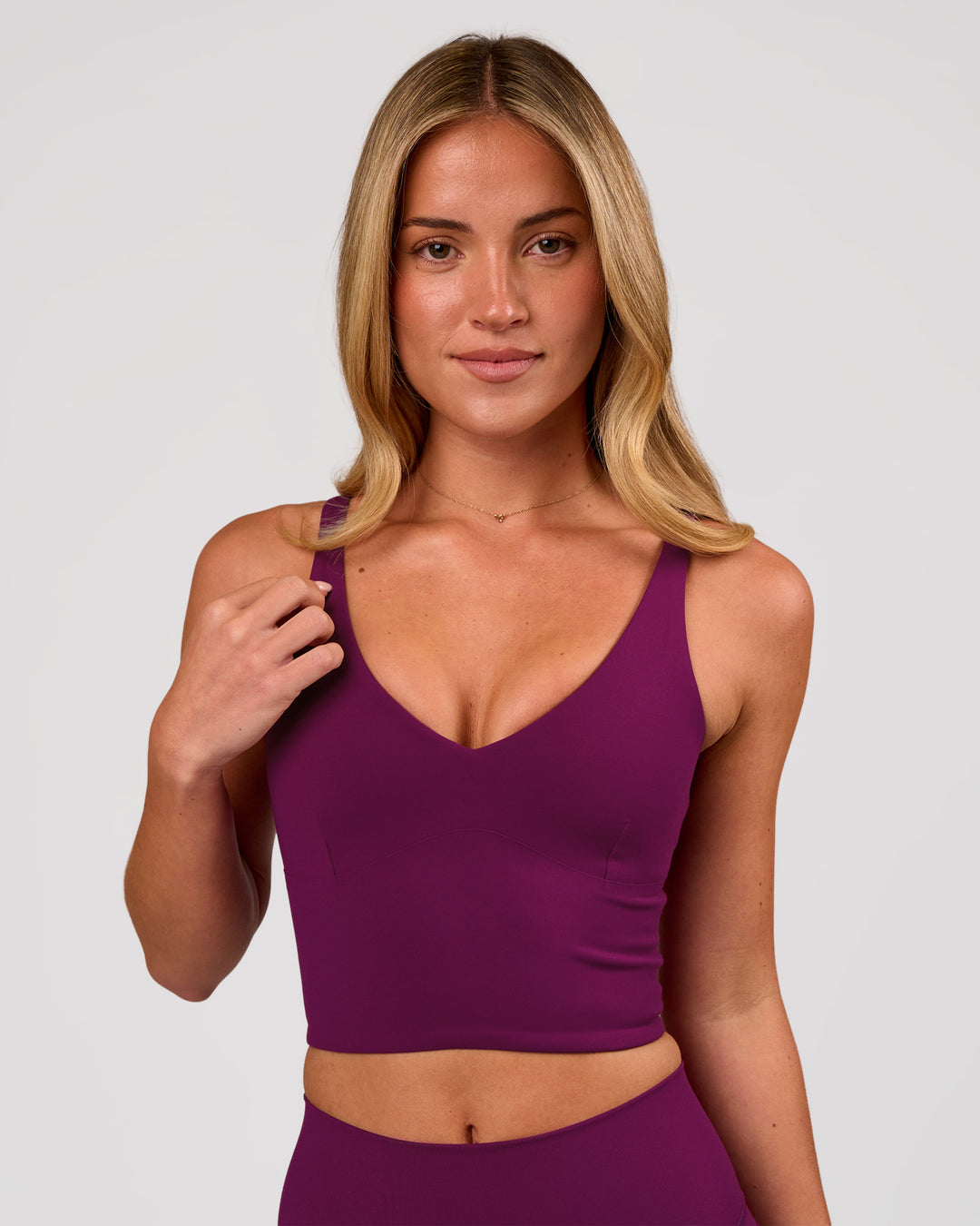 Woman wearing Vitality Long Line Sports Bra - Plum Caspia | Model:Issy | Size:XS - view 1