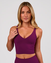 Woman wearing Vitality Long Line Sports Bra - Plum Caspia | Model:Issy | Size:XS | Thumbnail Index: 0