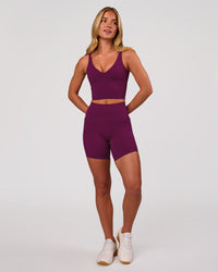 Woman wearing Vitality Long Line Sports Bra - Plum Caspia | Model:Issy | Size:XS | Thumbnail Index: 1