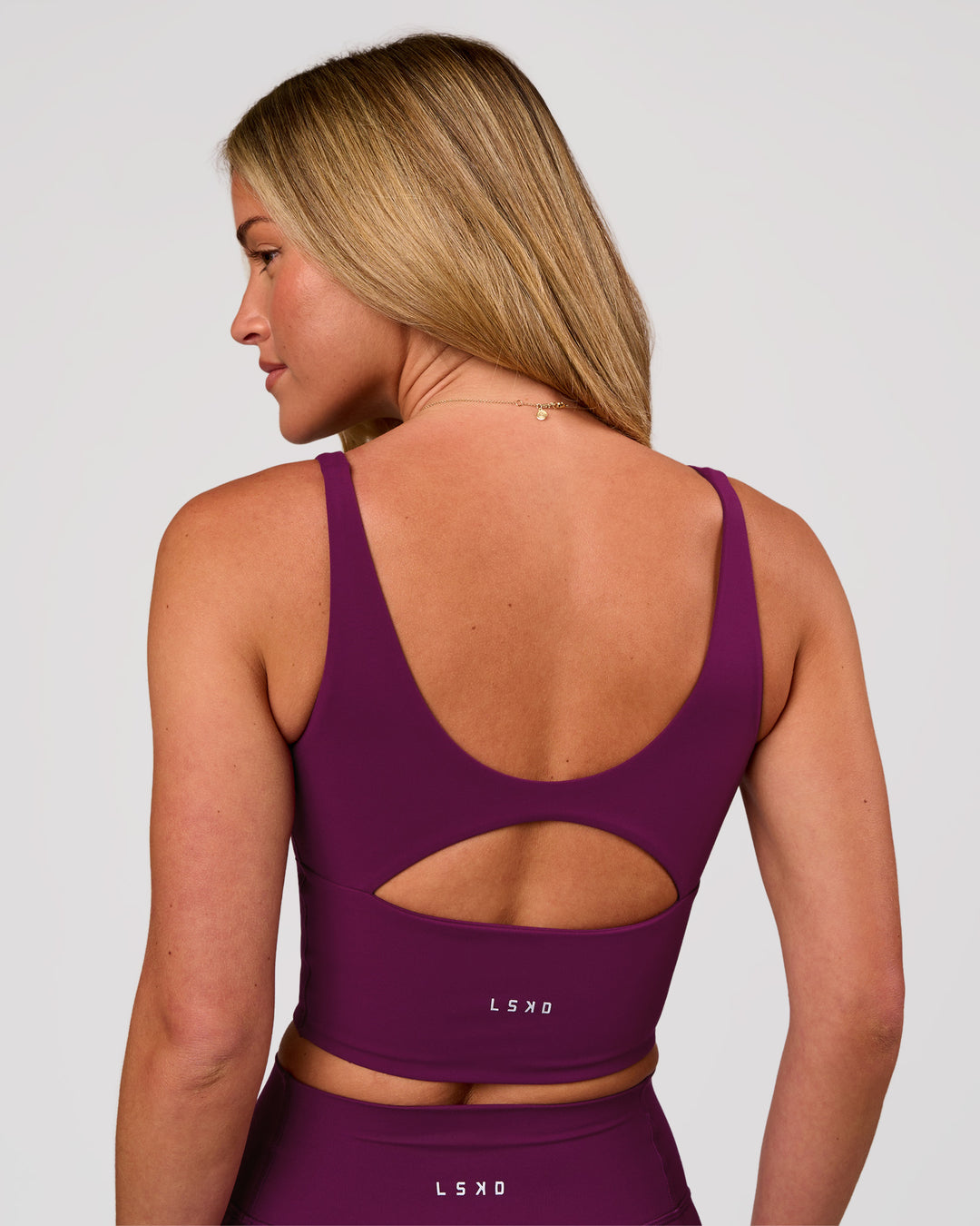 Woman wearing Vitality Long Line Sports Bra - Plum Caspia | Model:Issy | Size:XS - view 4