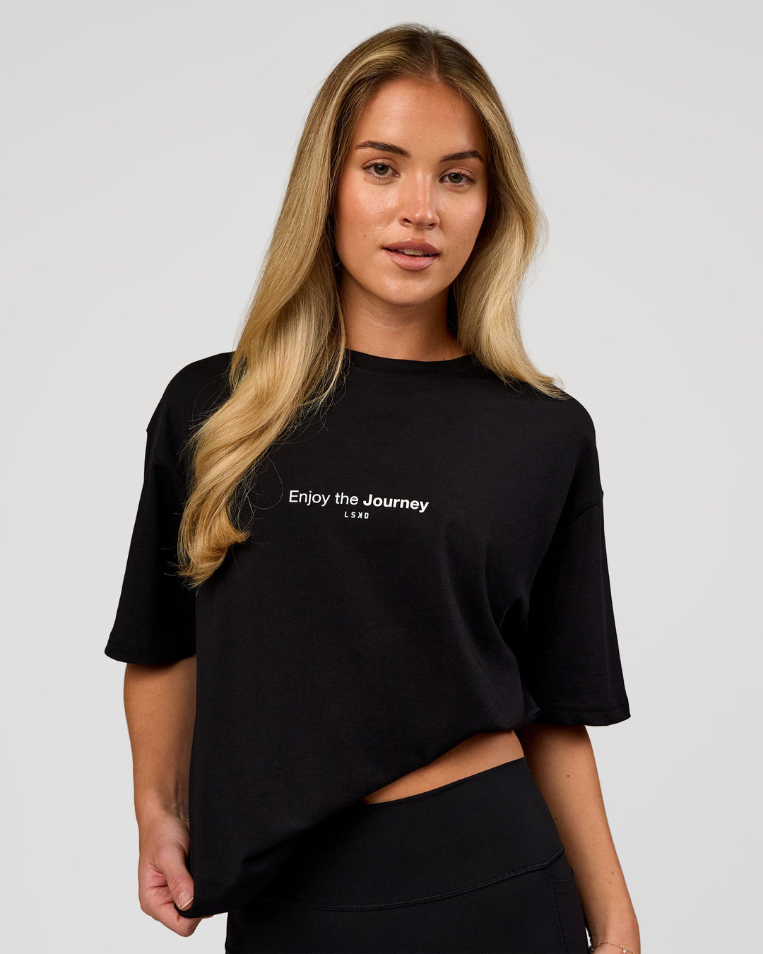 Woman wearing VS1 Enjoy The Journey FLXCotton Oversize Tee - Black | Model:Issy | Size:XS - view 3