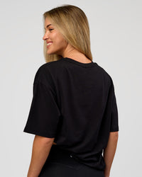 Woman wearing VS1 Enjoy The Journey FLXCotton Oversize Tee - Black | Model:Issy | Size:XS | Thumbnail Index: 4
