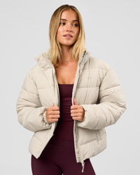 Woman wearing Go-To Puffer Jacket - Shale Beige | Model:Izzy | Size:XS