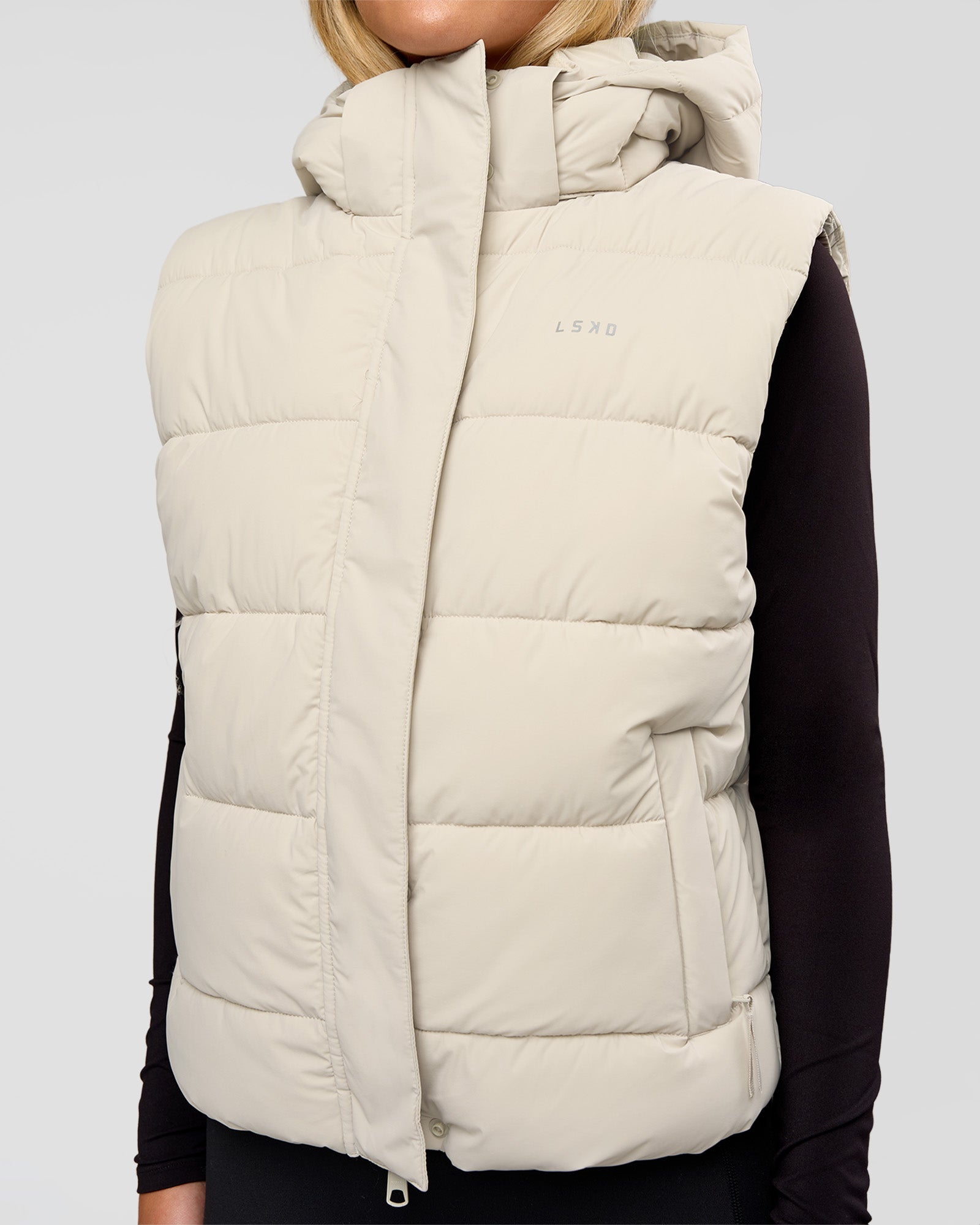 Woman wearing Go-To Puffer Vest - Shale Beige | Model:Izzy | Size:XS