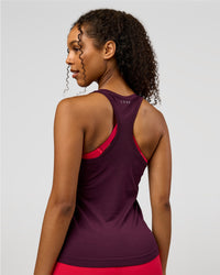 Woman wearing AeroFLX+ Seamless Tank - Cherry Lacquer/Cherry Lacquer | Model:Jordan | Size:XS | Thumbnail Index: 1