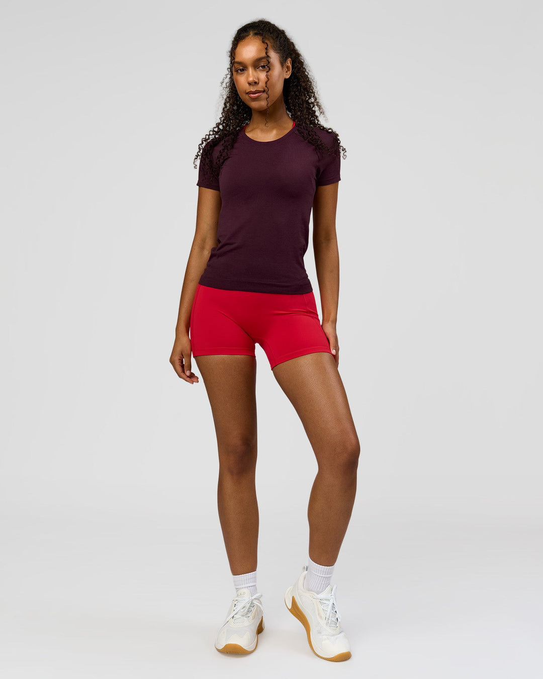 Woman wearing AeroFLX+ Seamless Tee - Cherry Lacquer/Cherry Lacquer | Model:Jordan | Size:XS - view 4
