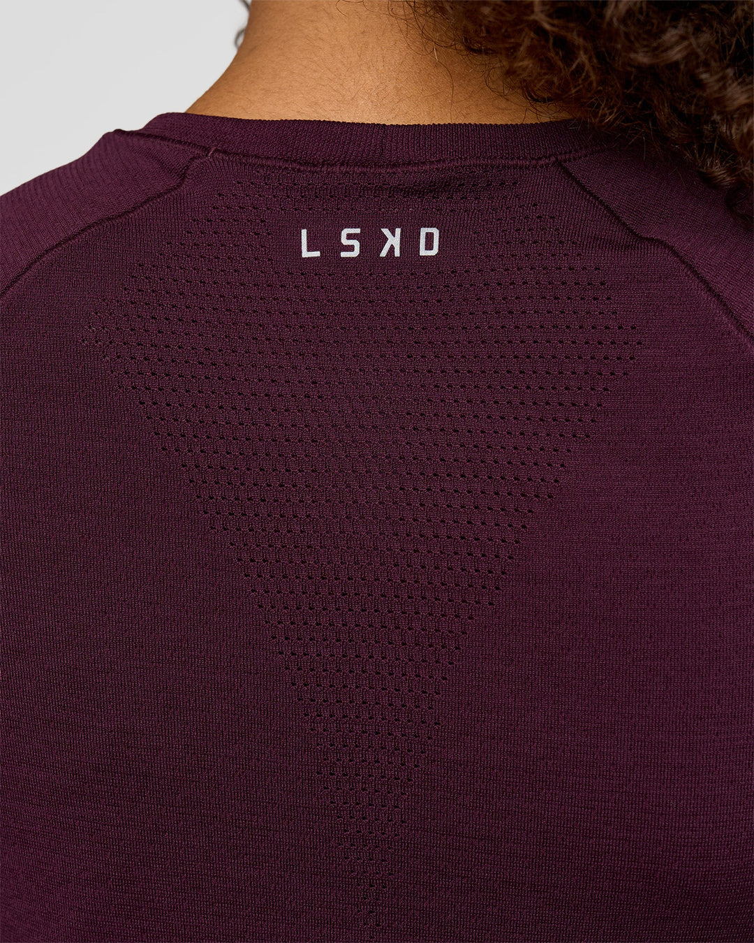 Woman wearing AeroFLX+ Seamless Tee - Cherry Lacquer/Cherry Lacquer | Model:Jordan | Size:XS - view 6