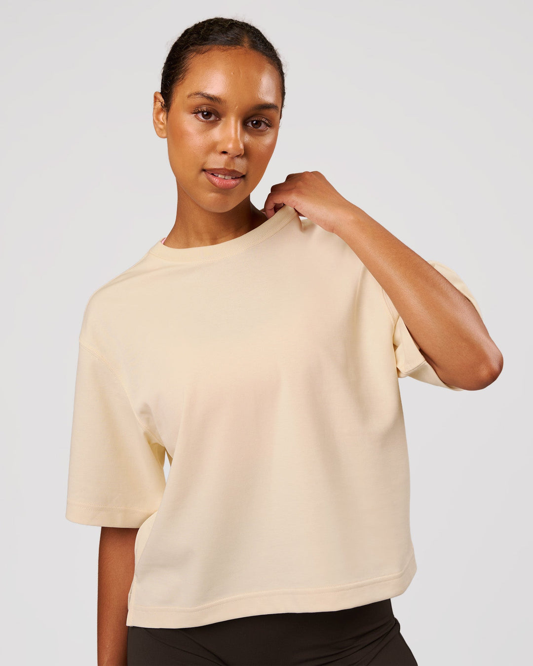 Woman wearing AfterDark ZeroCrease Cropped Tee - Vanilla Bean | Model:Jordan | Size:XS - view 1