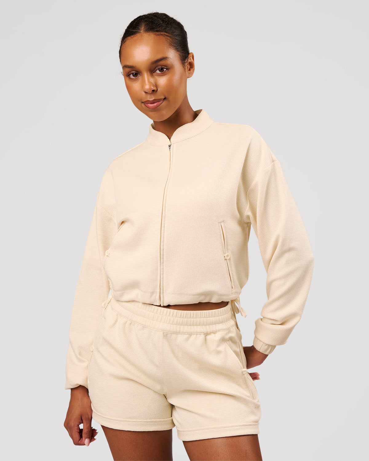 Woman wearing CloudWaffle Midi Zip Up - Vanilla Bean | Model:Jordan | Size:XS - view 1
