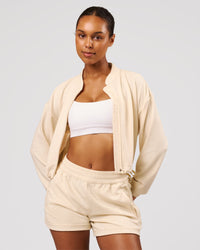 Woman wearing CloudWaffle Midi Zip Up - Vanilla Bean | Model:Jordan | Size:XS | Thumbnail Index: 1